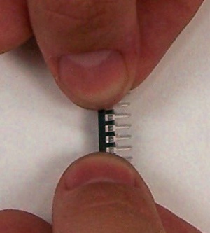 Carefully bend the leads of the chip slightly inward