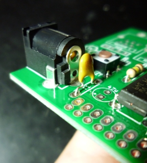 Insert the non-polarized part right behind the DC jack.