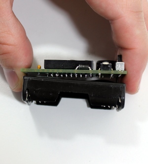 Insert leads of battery holder through PCB from the back